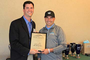PSIC Director of Sales, Jonathan Vitale, accepts award from SKIP's President Owen O'Malley